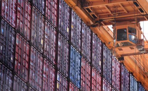 Stack of containers under a crane 
