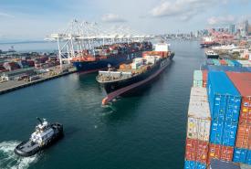 A tugboat pulling a container ship.